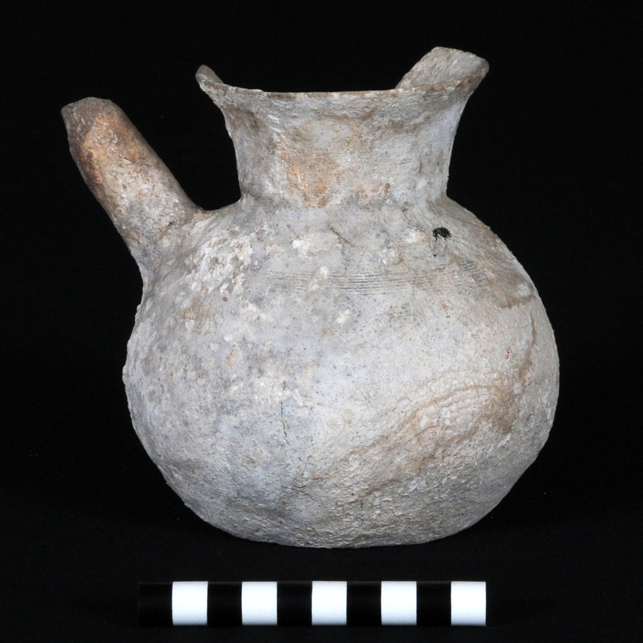 a grey pitcher with a spout