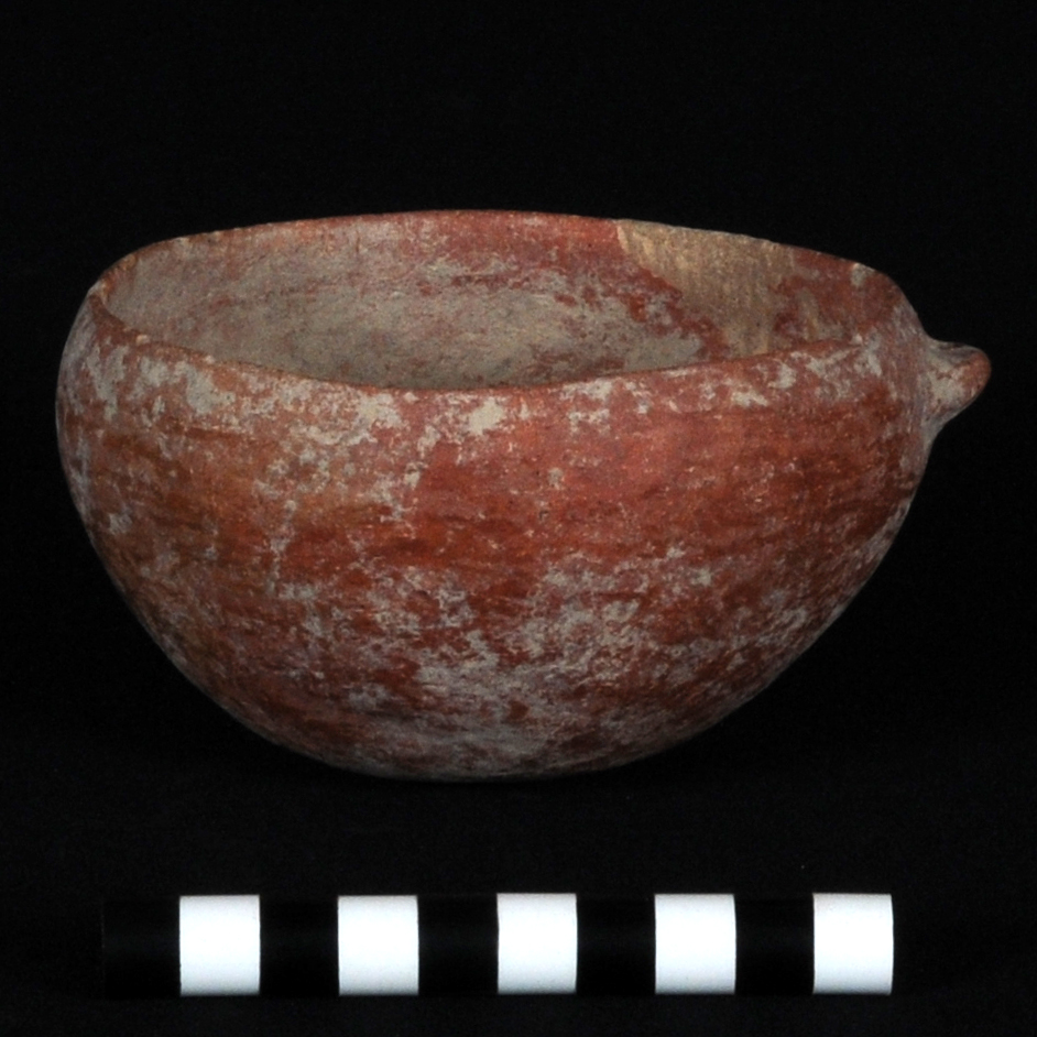 a reddish ledge-handled bowl