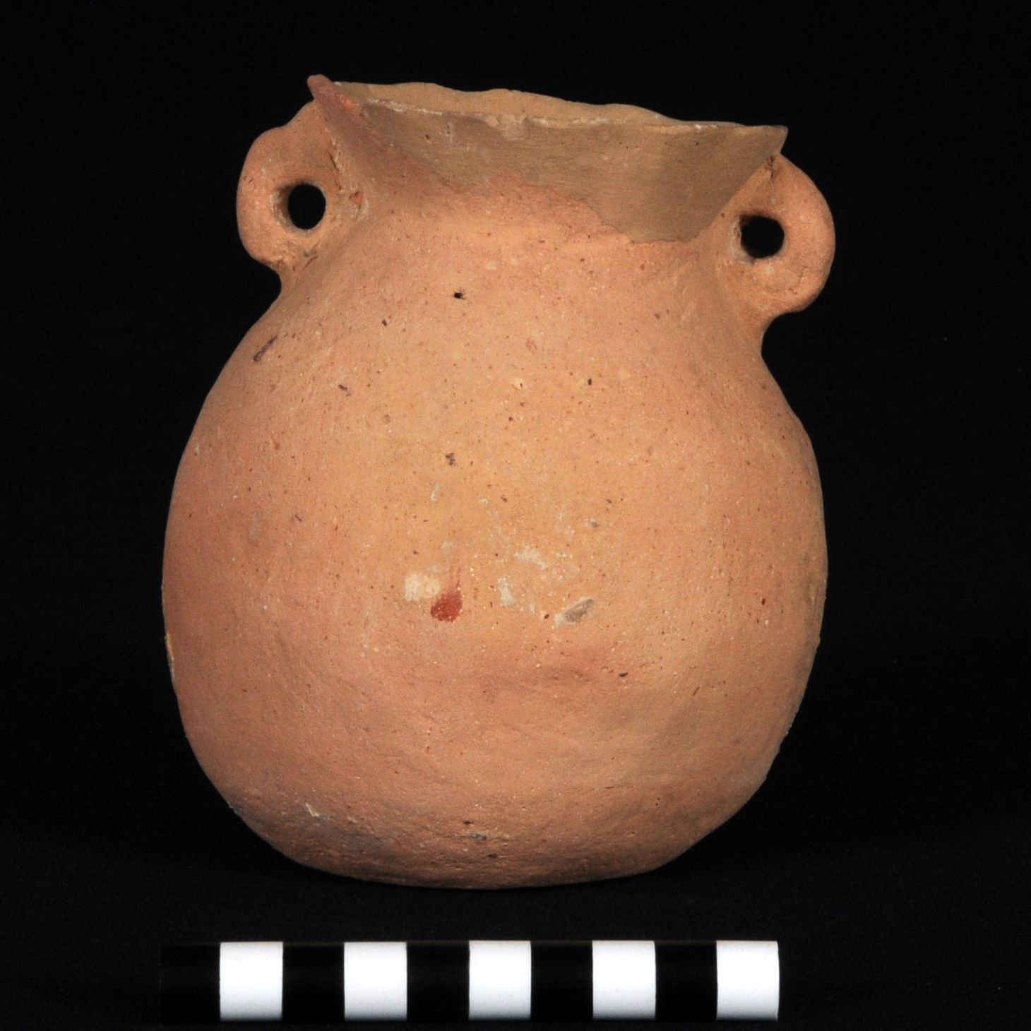 an orange lopsided jar