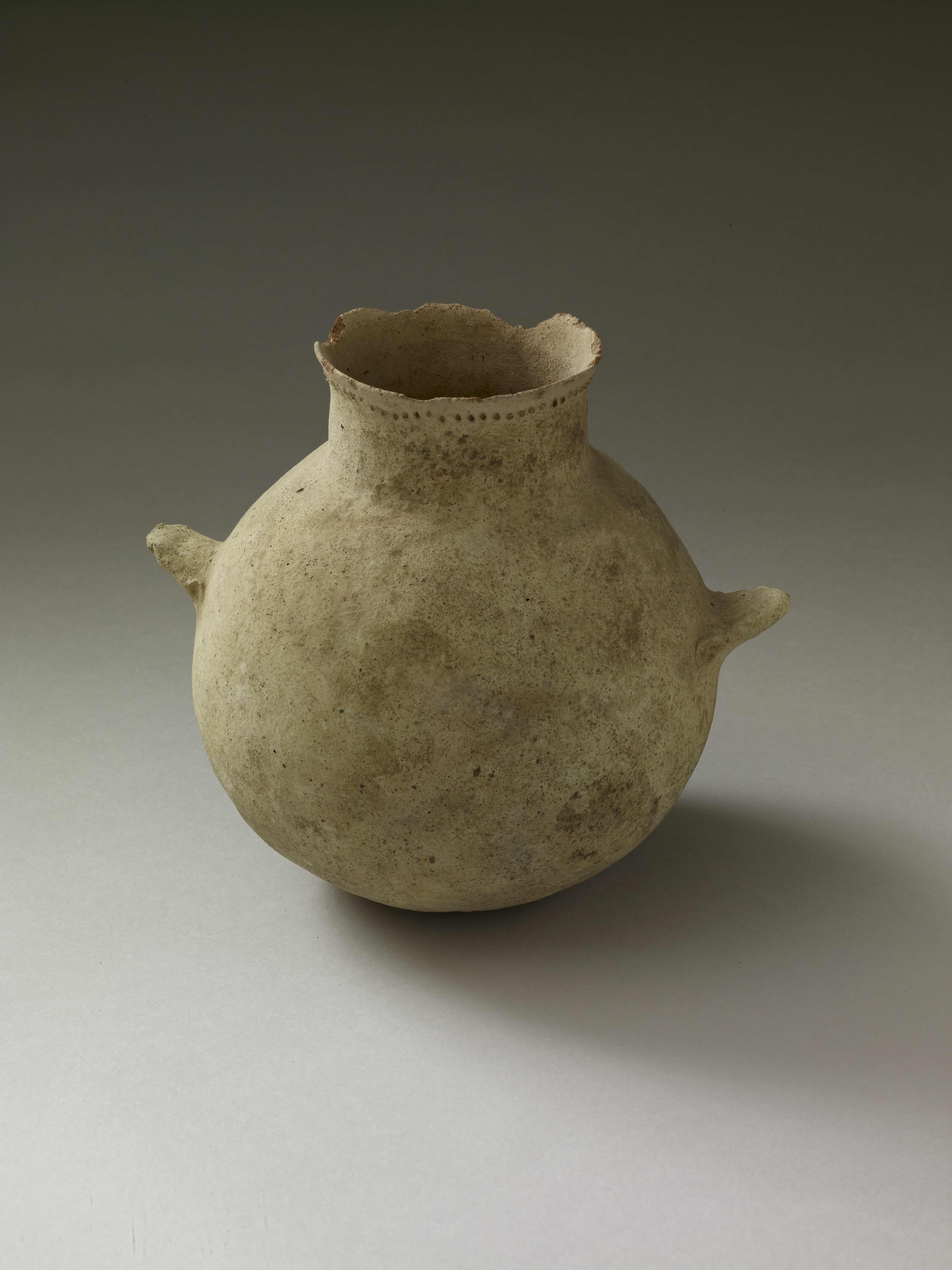 a light brown ledge-handled jar