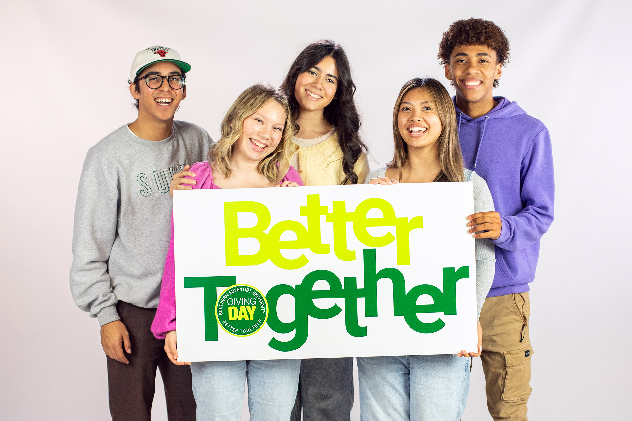 Students hold a sign that says Better Together.