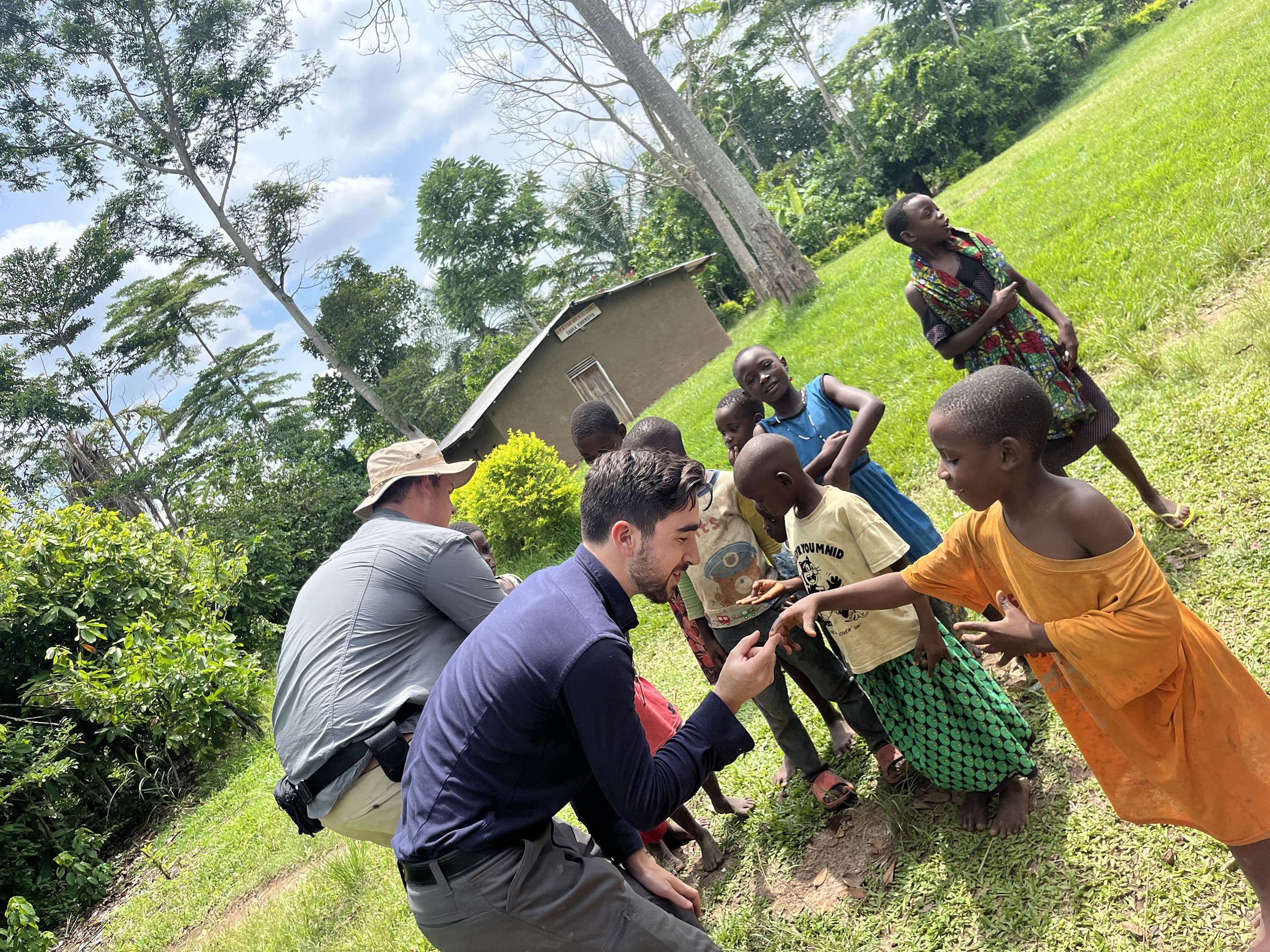 students interact with villagers in Uganda