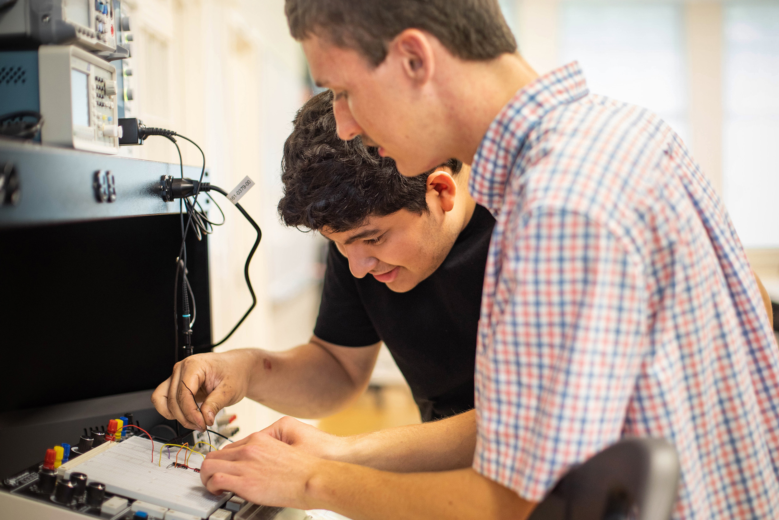 students in a lab work with wires
